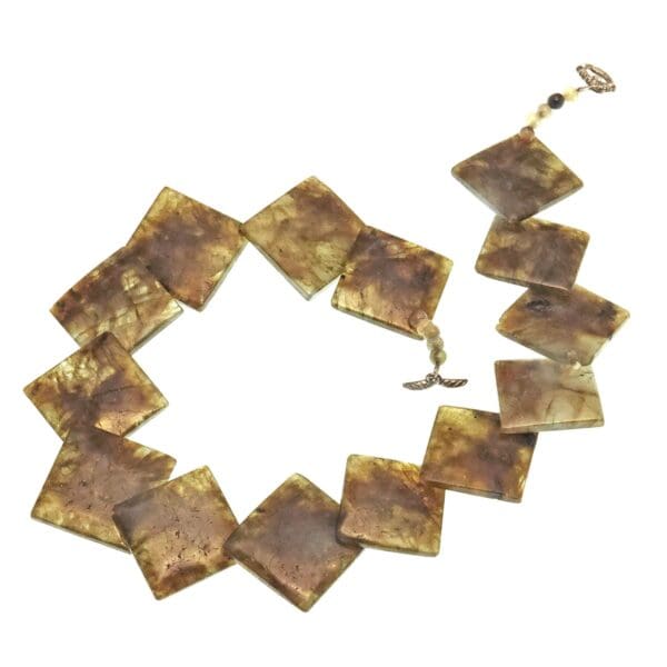 A necklace made of squares of brown paper.