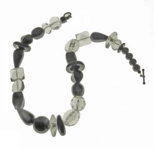 A necklace of polished Black and clear Lucite beads