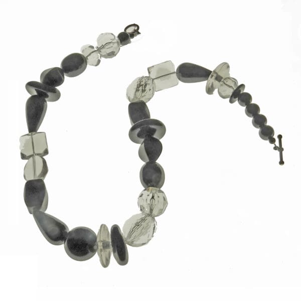 A necklace of polished Black and clear Lucite beads
